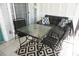 Relaxing lanai with table, chairs, and sofa at 2164 Vista Del Sol Cir # 505, Lutz, FL 33558