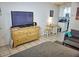 Living room with flat-screen TV, dresser, and kitchen view at 2164 Vista Del Sol Cir # 505, Lutz, FL 33558