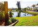 Serene pond with lush landscaping and palm trees at 2164 Vista Del Sol Cir # 505, Lutz, FL 33558
