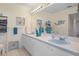 Bathroom with double vanity, light blue sinks, and tiled shower at 2263 Whisper Walk Dr, Spring Hill, FL 34606
