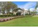 Community clubhouse with landscaping and a grand entrance at 2263 Whisper Walk Dr, Spring Hill, FL 34606