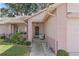 Brick-columned porch with white wicker chairs, offering a relaxing entryway at 2263 Whisper Walk Dr, Spring Hill, FL 34606