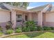 Attractive landscaping surrounds a covered porch with brick columns and accents at 2263 Whisper Walk Dr, Spring Hill, FL 34606
