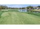 Golf course with manicured greens and a pond at 2263 Whisper Walk Dr, Spring Hill, FL 34606