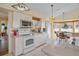 Kitchen boasts white cabinets, stainless steel appliances, and a breakfast nook at 2263 Whisper Walk Dr, Spring Hill, FL 34606