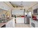 Kitchen features white cabinets, stainless steel appliances, and a breakfast nook at 2263 Whisper Walk Dr, Spring Hill, FL 34606