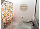 Bathroom featuring a granite countertop, white sink, and shower with a colorful shower curtain at 227 Hibiscus St, Tarpon Springs, FL 34689