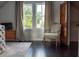 Bedroom showcasing dark wood floors, an ornate chair, and natural light from the windows at 227 Hibiscus St, Tarpon Springs, FL 34689