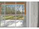 View from inside the home showcases a large backyard and trees at 23089 Grubbs Rd, Brooksville, FL 34601