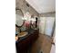 Charming bathroom featuring dual sinks, intricate wallpaper, decorative mirrors, and sliding door closet at 30 Turner St # 208, Clearwater, FL 33756