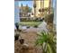Charming courtyard featuring a stone walkway, lush greenery, and potted plants, providing a serene outdoor space at 30 Turner St # 208, Clearwater, FL 33756