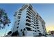 Contemporary condo building with multiple balconies, palm trees, and parking at 30 Turner St # 208, Clearwater, FL 33756