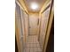 Hallway with tiled floor, white doors, and neutral yellow walls leading to other areas at 30 Turner St # 208, Clearwater, FL 33756
