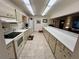 Functional kitchen with ample counter space, neutral cabinetry, and standard appliances at 30 Turner St # 208, Clearwater, FL 33756