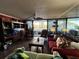 Cozy living room featuring comfortable seating, shelving, and a beautiful balcony view at 30 Turner St # 208, Clearwater, FL 33756