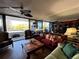 Warm living room featuring couches, large windows with balcony access and a great view at 30 Turner St # 208, Clearwater, FL 33756