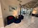Cozy lobby seating area with plush armchairs, accent table, and turtle artwork at 30 Turner St # 208, Clearwater, FL 33756