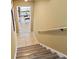 Stairs to basement game room featuring tile floors and a door leading to a game room with a ping pong table at 4034 Cobia Dr, Hernando Beach, FL 34607