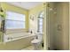 Bathroom featuring a large tub, separate shower, and a window for natural light at 4034 Cobia Dr, Hernando Beach, FL 34607