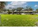Lush green backyard with canal access and dock views at 5648 Riverview Dr, New Port Richey, FL 34652