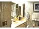 Bathroom with sink, medicine cabinet, and patterned wallpaper at 6124 Chesham Dr # 6, New Port Richey, FL 34653