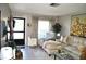 Bright living room with a sectional sofa, armchair, and access to the exterior at 6124 Chesham Dr # 6, New Port Richey, FL 34653