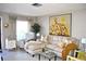 Living room boasts a sectional sofa, armchair, and large-scale artwork at 6124 Chesham Dr # 6, New Port Richey, FL 34653