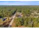 A high angle aerial view of a home nestled within a large, wooded suburban area at 7482 Winter St, Brooksville, FL 34613