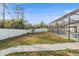 Backyard with a green lawn, a quaint stepping stone walkway and white vinyl fencing at 7482 Winter St, Brooksville, FL 34613