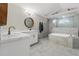 Elegant bathroom features double sink vanity, soaking tub, and glass shower at 7482 Winter St, Brooksville, FL 34613
