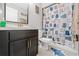 Updated bathroom with a dark vanity, gold hardware, and a playful cat shower curtain at 7482 Winter St, Brooksville, FL 34613