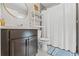 Bathroom showcasing dark vanity with modern fixtures, a large mirror, and a walk-in shower at 7482 Winter St, Brooksville, FL 34613