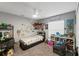 Neutral bedroom with ceiling fan, comfortable bed and playful dinosaur decor at 7482 Winter St, Brooksville, FL 34613