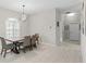A dining area featuring tile floors, a modern light fixture, and a window with plantation shutters at 7482 Winter St, Brooksville, FL 34613