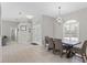 A dining area featuring tile floors, a modern light fixture, and a window with plantation shutters at 7482 Winter St, Brooksville, FL 34613
