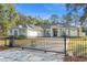 Charming single story home featuring a gated driveway and a well-manicured lawn at 7482 Winter St, Brooksville, FL 34613