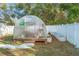 Backyard greenhouse with raised garden beds, ideal for cultivating plants and vegetables at 7482 Winter St, Brooksville, FL 34613