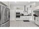 Kitchen featuring sleek stainless steel appliances, white cabinetry, and modern finishes at 7482 Winter St, Brooksville, FL 34613