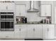 Close up of the kitchen, highlighting the stainless steel appliances and white subway tile backsplash at 7482 Winter St, Brooksville, FL 34613