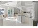 Open kitchen with island, granite counters, stainless appliances, and white cabinets at 7482 Winter St, Brooksville, FL 34613