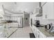 Spacious kitchen boasting white cabinets, stainless steel appliances, granite countertops, and modern fixtures at 7482 Winter St, Brooksville, FL 34613