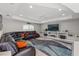 Spacious living room featuring a large leather sectional sofa, a ceiling fan, and a built-in media center at 7482 Winter St, Brooksville, FL 34613