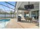 Spacious patio with an outdoor dining area adjacent to the screened-in swimming pool at 7482 Winter St, Brooksville, FL 34613