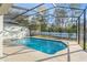 Screened-in pool with clear blue water and spacious deck, perfect for outdoor enjoyment at 7482 Winter St, Brooksville, FL 34613