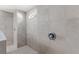 Modern tiled shower with built-in bench and shower head at 7482 Winter St, Brooksville, FL 34613