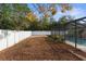 Large backyard with a privacy fence and mature trees at 7489 Gates Cir, Spring Hill, FL 34606