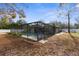 Spacious backyard with screened pool and fenced perimeter at 7489 Gates Cir, Spring Hill, FL 34606