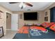 Bedroom with a double bed, a large TV, and a ceiling fan at 7489 Gates Cir, Spring Hill, FL 34606