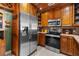Kitchen with stainless steel appliances and wood cabinetry at 7489 Gates Cir, Spring Hill, FL 34606