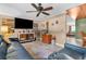 Relaxing living room featuring a large sectional sofa and ceiling fan at 7489 Gates Cir, Spring Hill, FL 34606
